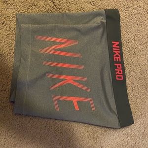 Nike pros with pink lettering